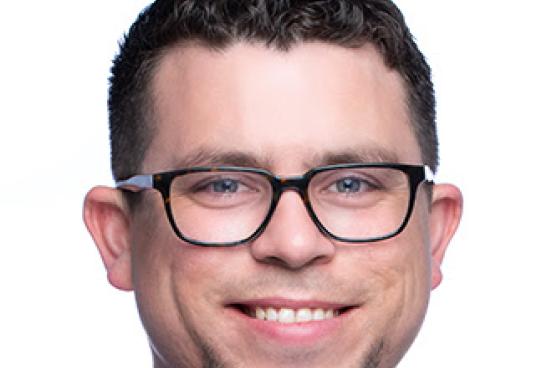 Smiling man, wearing glasses